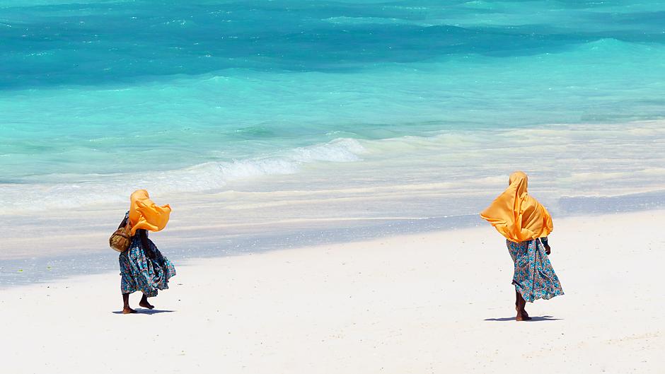 Women walking on beach in Tanzania